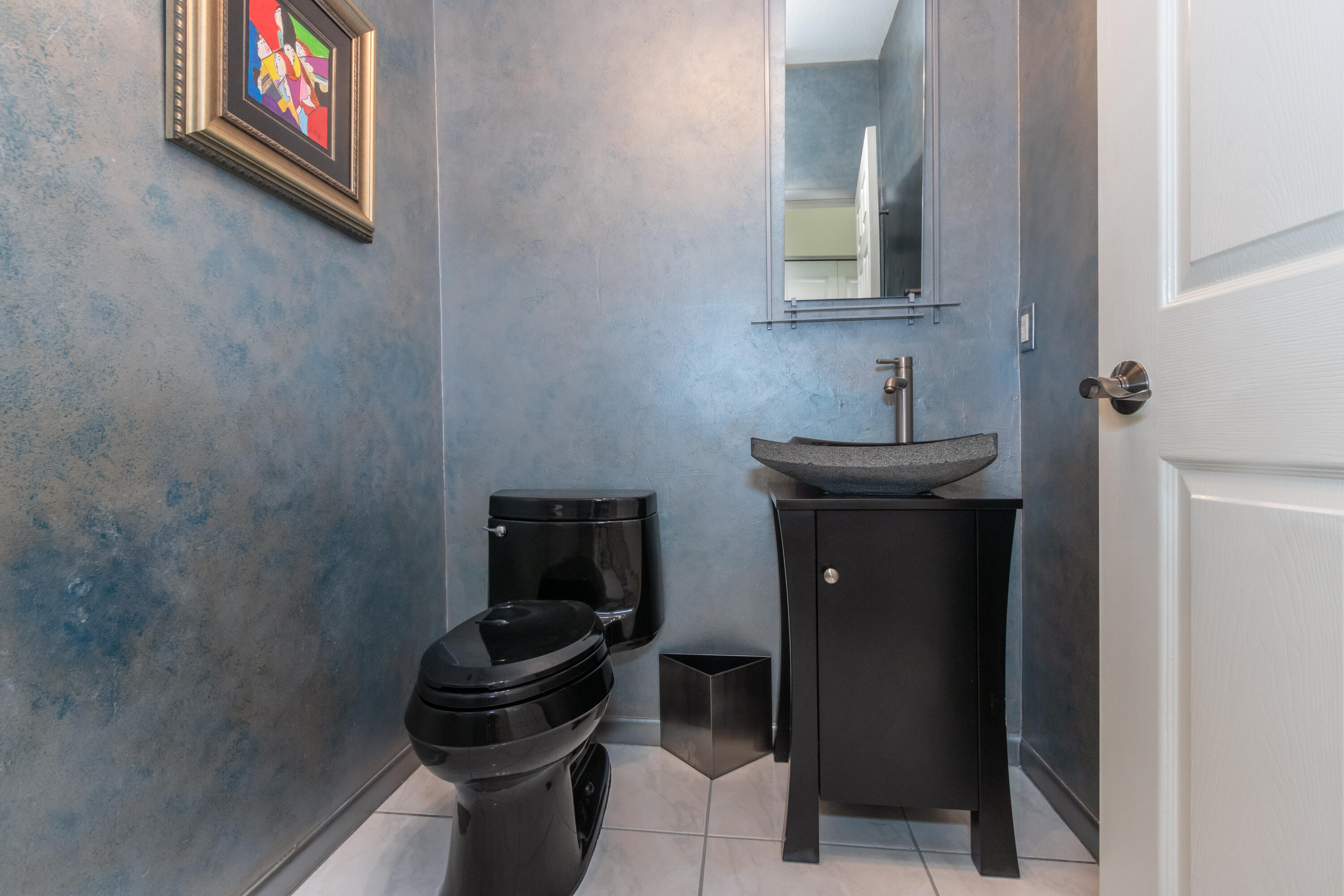 23402 Torre Circle Boca Raton, FL 33433 - Photo 31 of 44 a bathroom with a toilet a sink and mirror