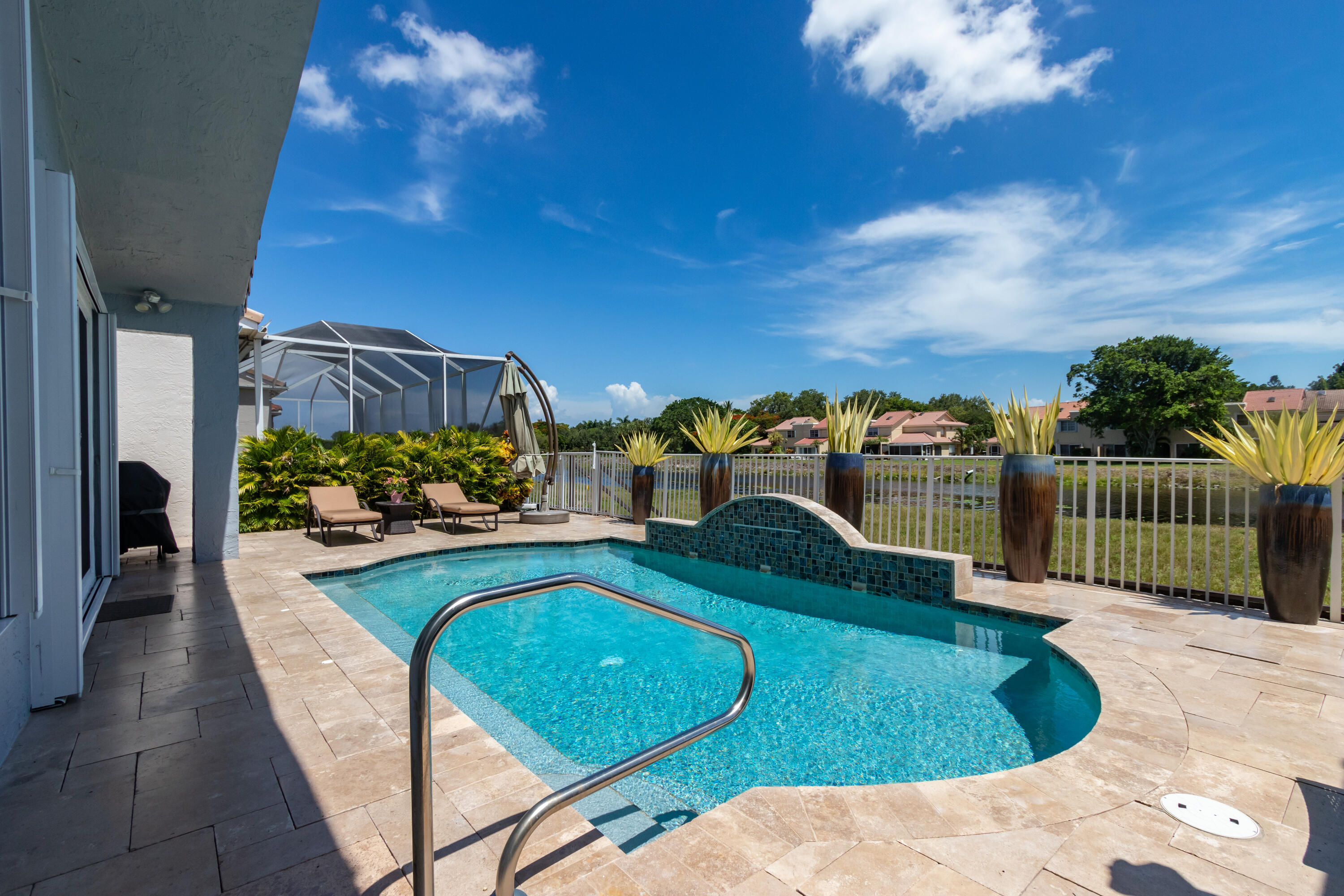 23402 Torre Circle Boca Raton, FL 33433 - Photo 33 of 44 a view of a swimming pool with a patio and a yard