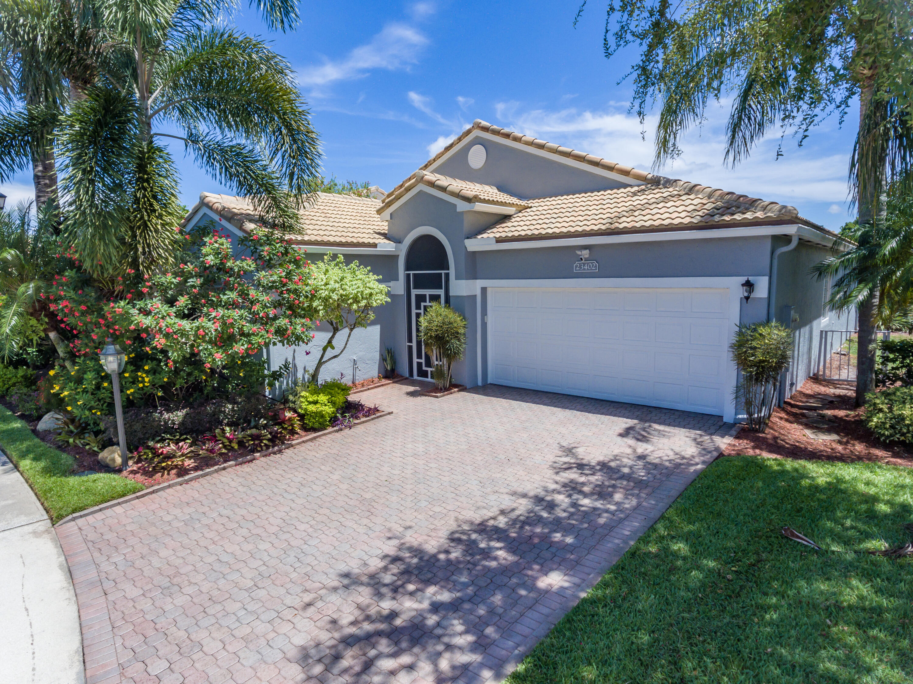 23402 Torre Circle Boca Raton, FL 33433 - Photo 35 of 44 a front view of a house with garden
