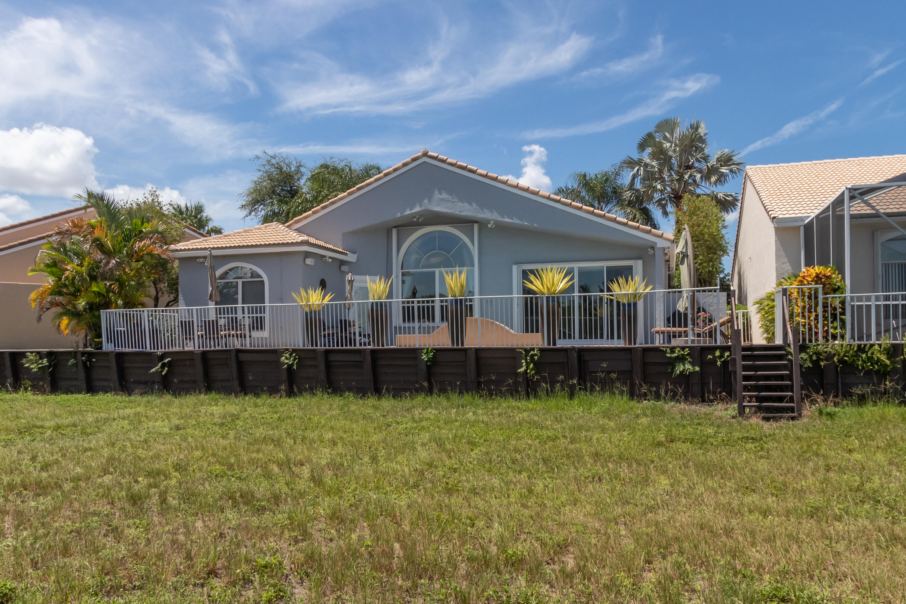 23402 Torre Circle Boca Raton, FL 33433 - Photo 36 of 44 a view of house with a big yard and large trees