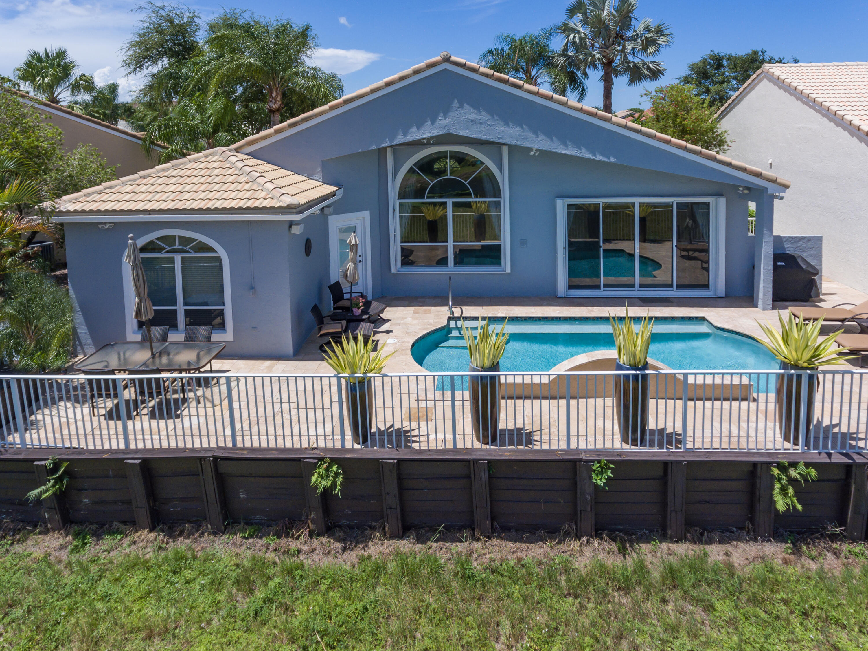 23402 Torre Circle Boca Raton, FL 33433 - Photo 37 of 44 a front view of a house with a garden