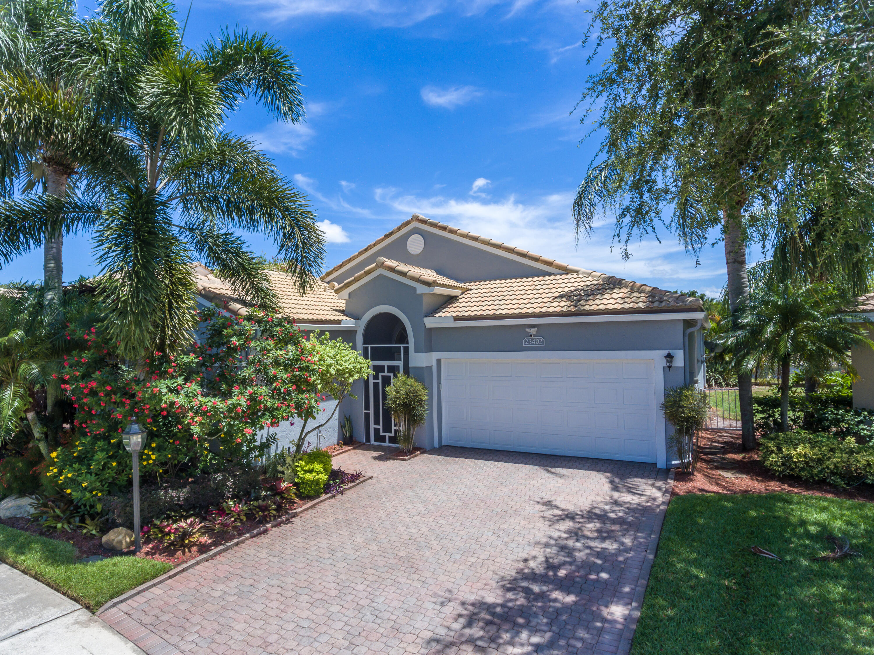 23402 Torre Circle Boca Raton, FL 33433 - Photo 43 of 44 a front view of a house with a yard and garage