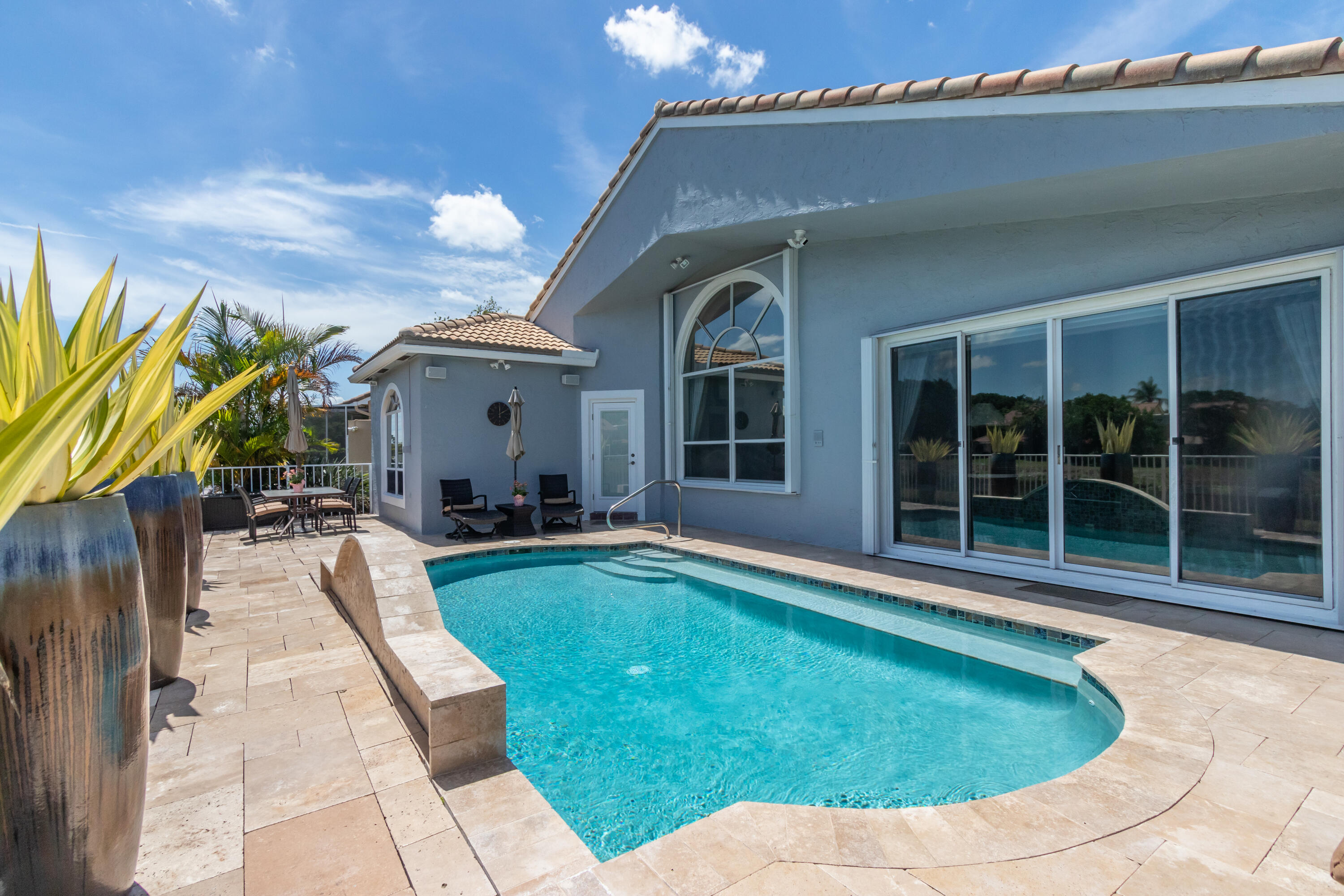 23402 Torre Circle Boca Raton, FL 33433 - Photo 5 of 44 a view of a house with swimming pool and porch with furniture