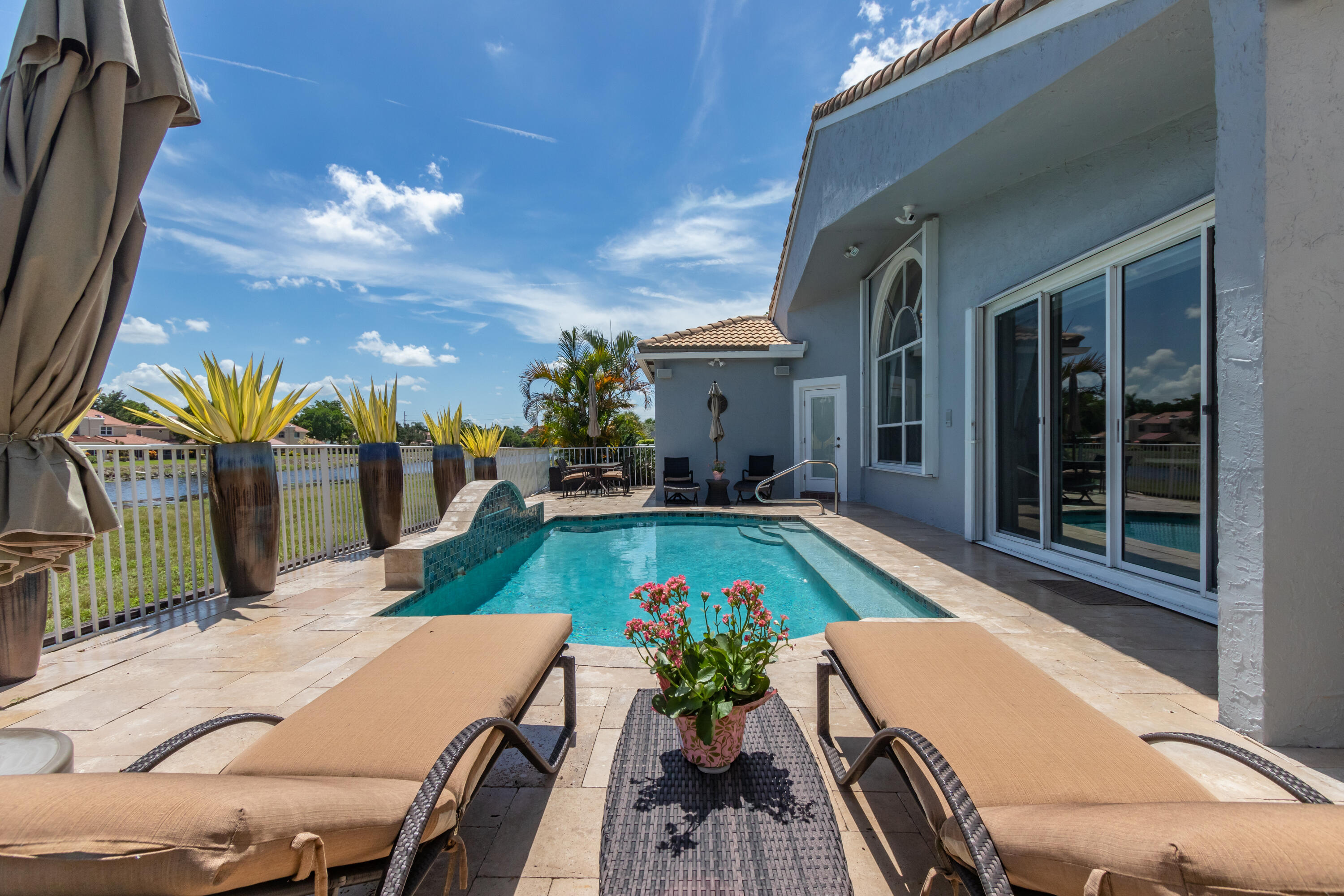 23402 Torre Circle Boca Raton, FL 33433 - Photo 6 of 44 a view of a patio with swimming pool and furniture