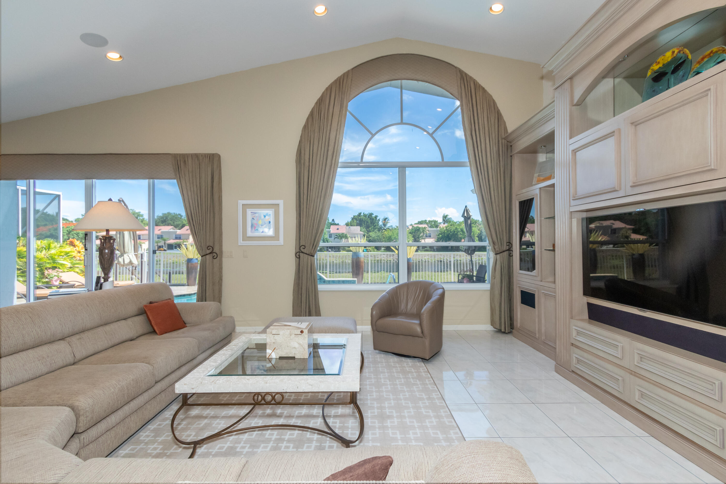 23402 Torre Circle Boca Raton, FL 33433 - Photo 10 of 44 a living room with furniture a fireplace and a floor to ceiling window
