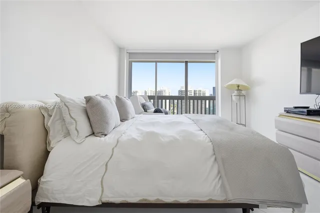 a large white bed in a white room