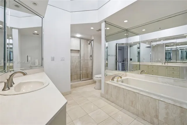 a spacious bathroom with a tub sink a shower a mirror and a sink