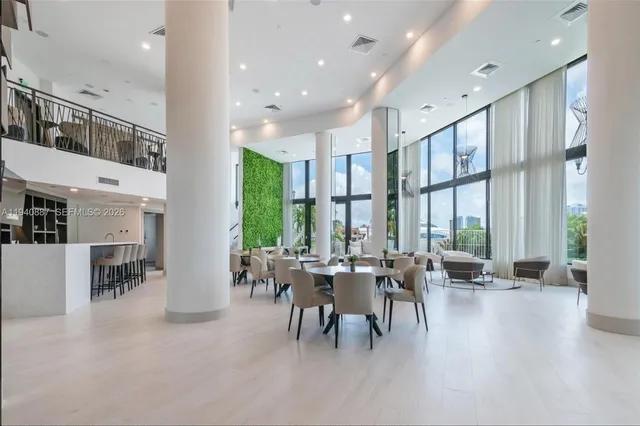 a very nice looking living room with furniture and a large window