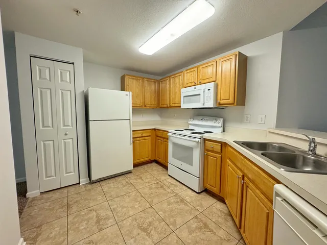 a kitchen with appliances cabinets and a sink