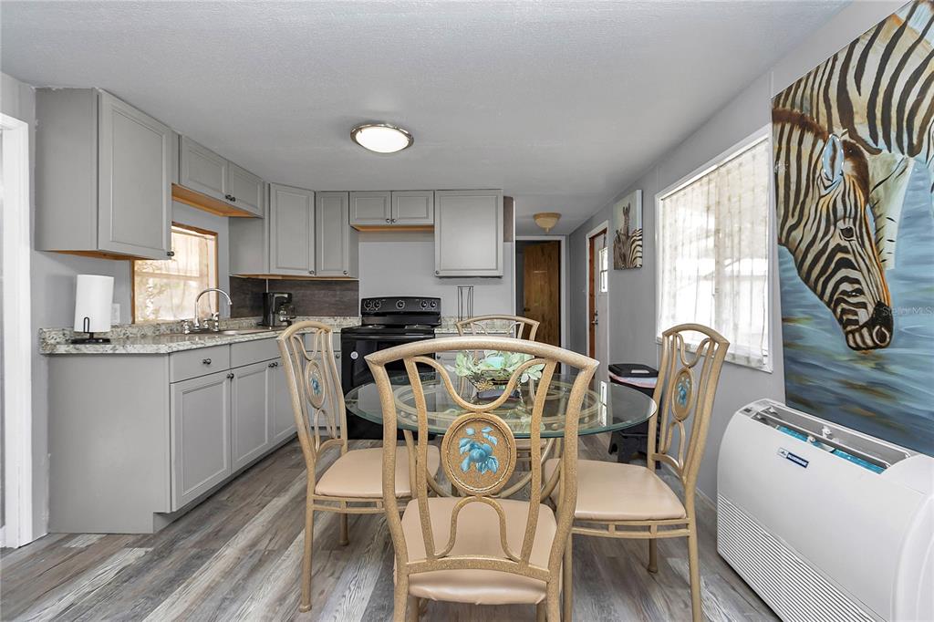 3003 Northeast 165th Lane Citra, FL 32113 - Photo 11 of 40 a view of a dining room with furniture window and wooden floor