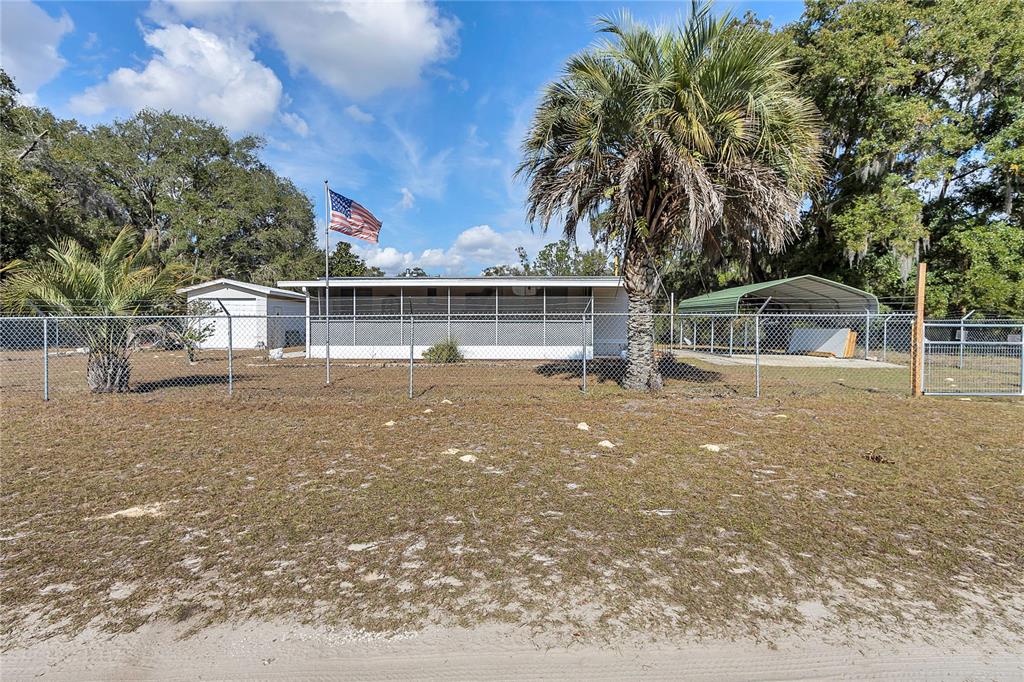 3003 Northeast 165th Lane Citra, FL 32113 - Photo 2 of 40 a front view of house with yard and trees around