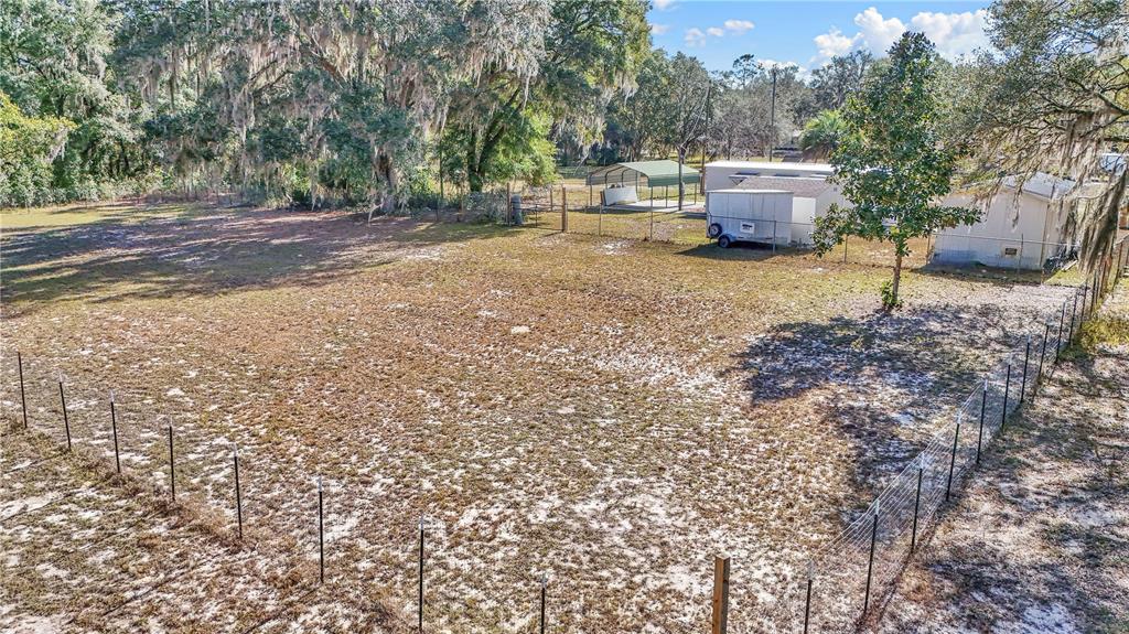 3003 Northeast 165th Lane Citra, FL 32113 - Photo 38 of 40 a wooden bench sitting in the middle of a yard