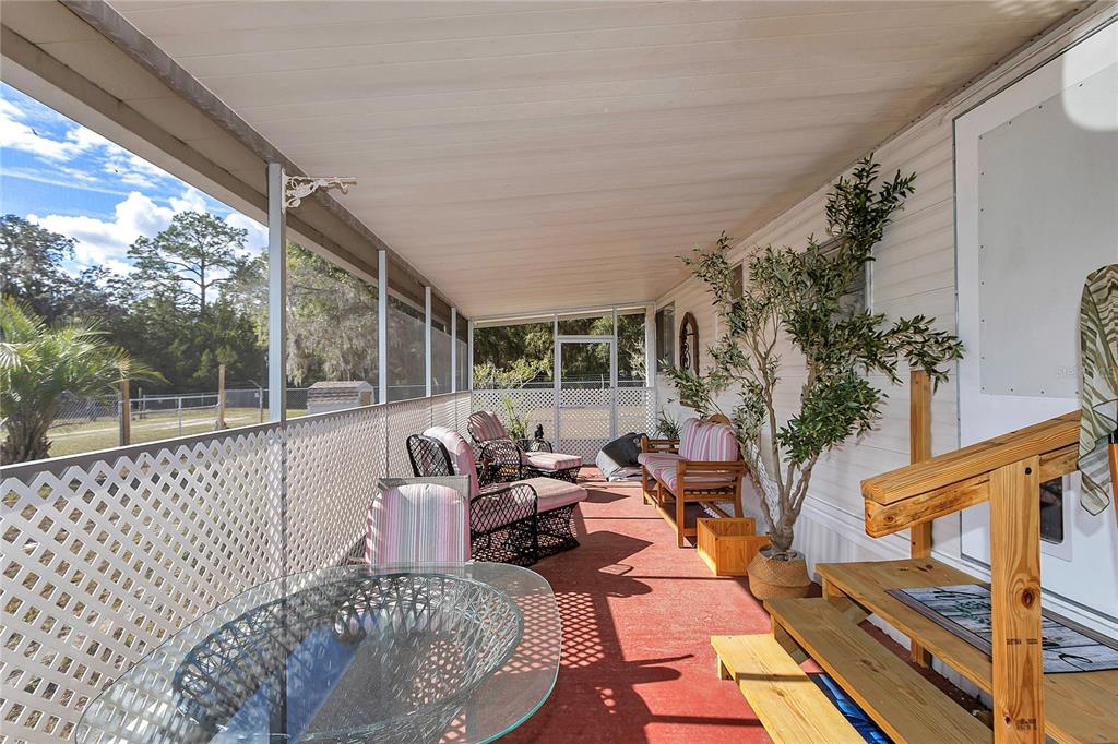 3003 Northeast 165th Lane Citra, FL 32113 - Photo 6 of 40 a balcony with furniture and a potted plant