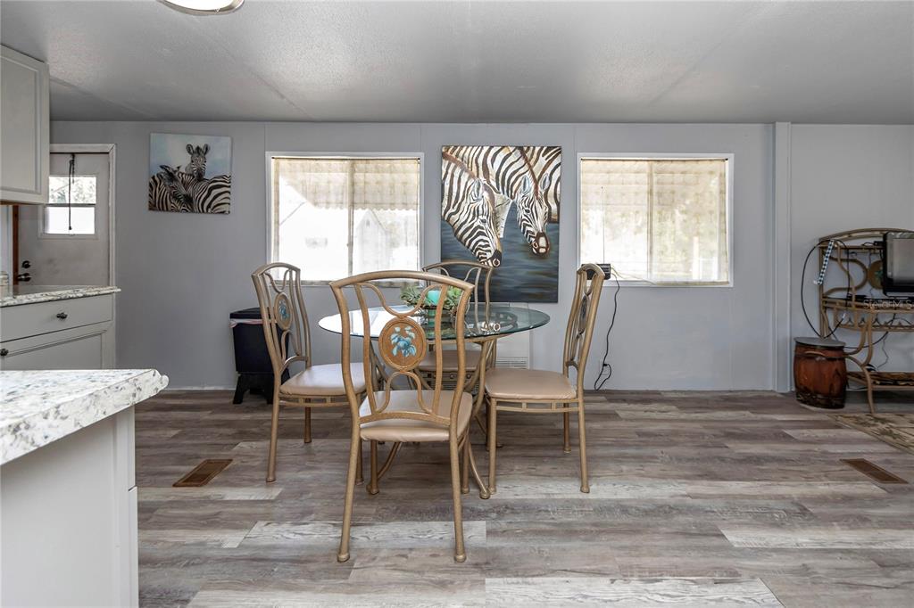3003 Northeast 165th Lane Citra, FL 32113 - Photo 8 of 40 a dining room with furniture and window