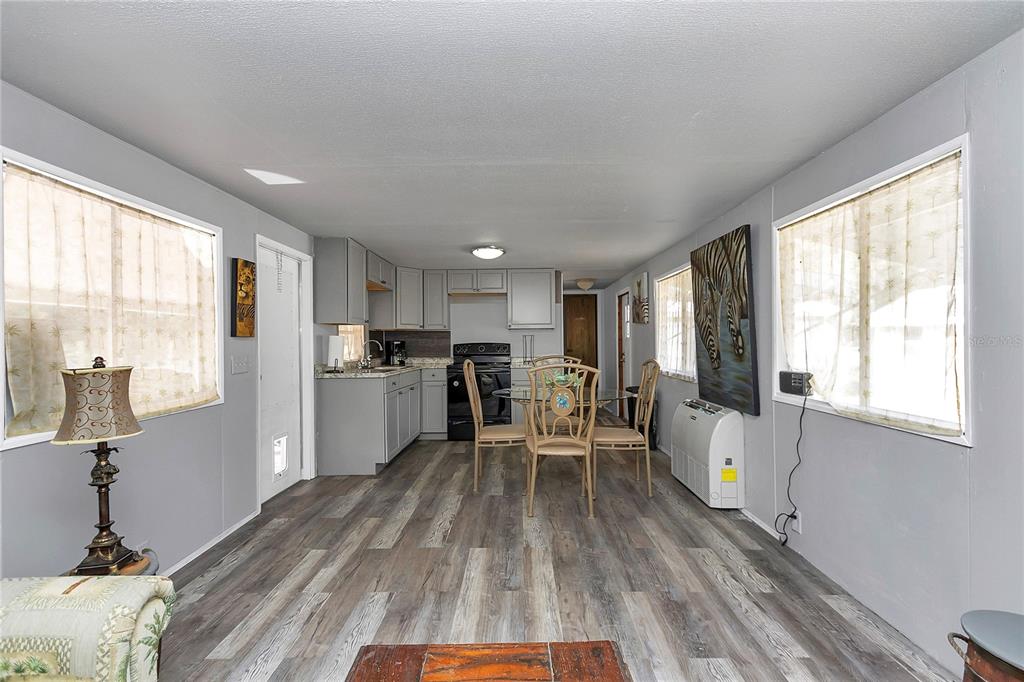 3003 Northeast 165th Lane Citra, FL 32113 - Photo 10 of 40 a kitchen with a table chairs refrigerator and window