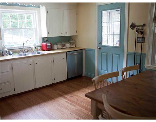 197 Hines Road Cumberland, RI 02864 - Photo 6 of 17 Kitchen. Bright sunny kitchen in the morning. Yes, that is a stainless diswasher. Open the door to the enclosed screened side porch for additional space.