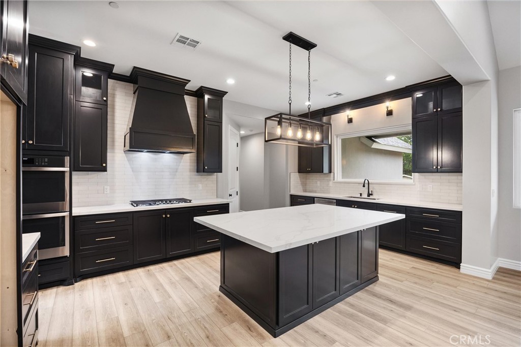 21116 Stage Drive Tehachapi, CA 93561 - Photo 18 of 46 a large kitchen with kitchen island a sink stainless steel appliances and cabinets