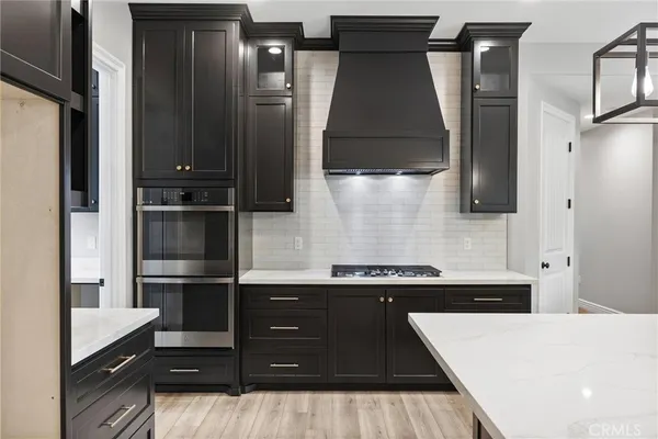 a kitchen with a refrigerator and cabinets