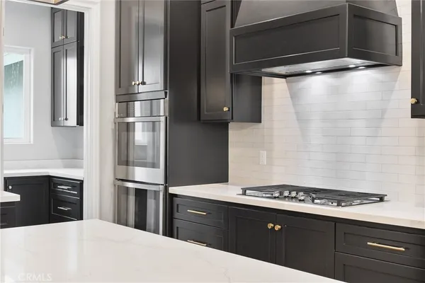a kitchen with granite countertop a refrigerator and a stove