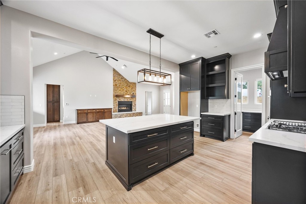 21116 Stage Drive Tehachapi, CA 93561 - Photo 24 of 46 a kitchen with stainless steel appliances granite countertop a sink a stove and a wooden floors