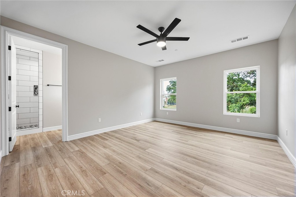 21116 Stage Drive Tehachapi, CA 93561 - Photo 26 of 46 an empty room with wooden floor and windows