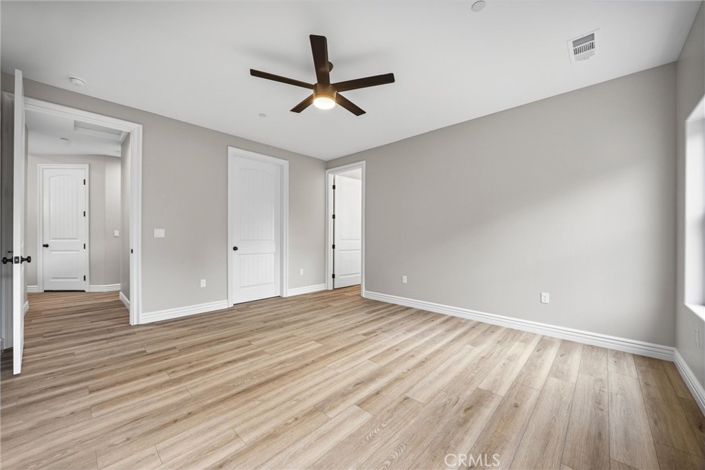 21116 Stage Drive Tehachapi, CA 93561 - Photo 27 of 46 an empty room with wooden floor and a ceiling fan