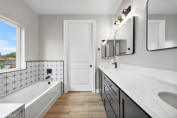 a bathroom with a bathtub and next to a window