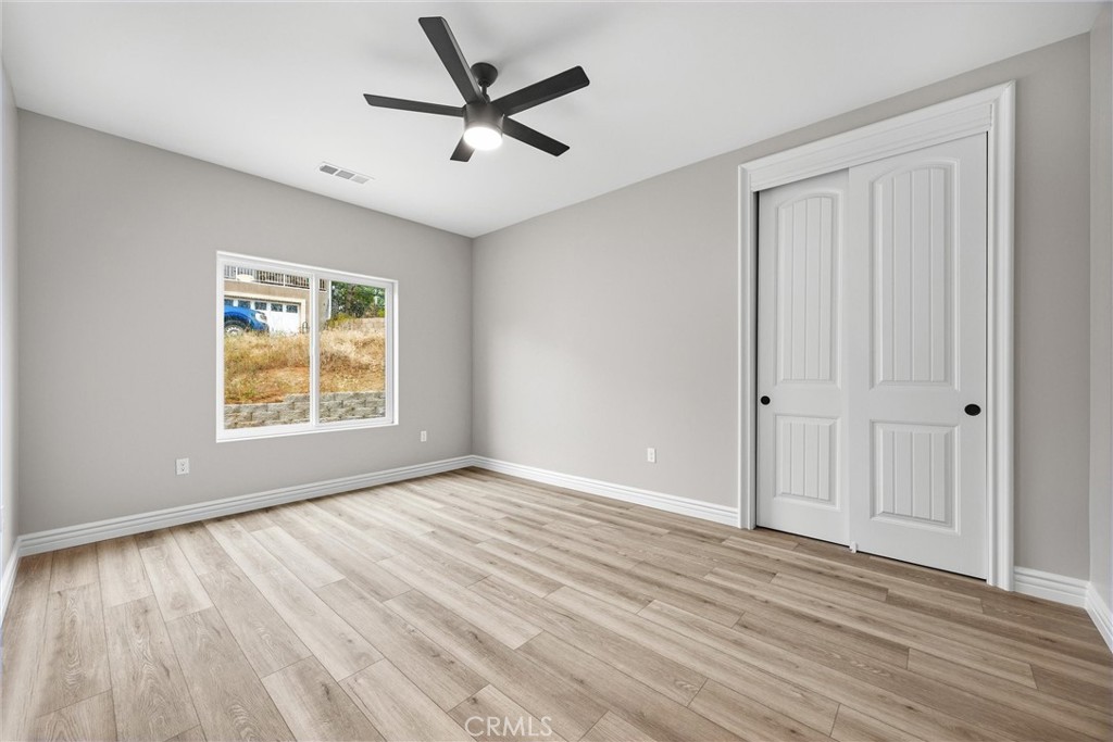 21116 Stage Drive Tehachapi, CA 93561 - Photo 36 of 46 an empty room with wooden floor and windows