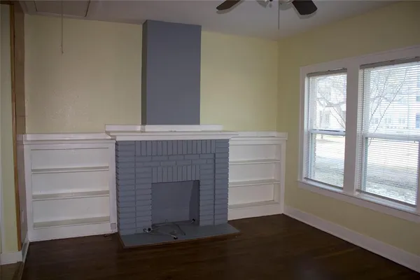 a room with a fireplace and wooden floor
