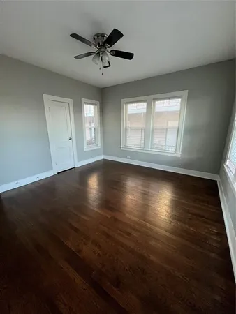 a view of a livingroom with wooden floor and a window