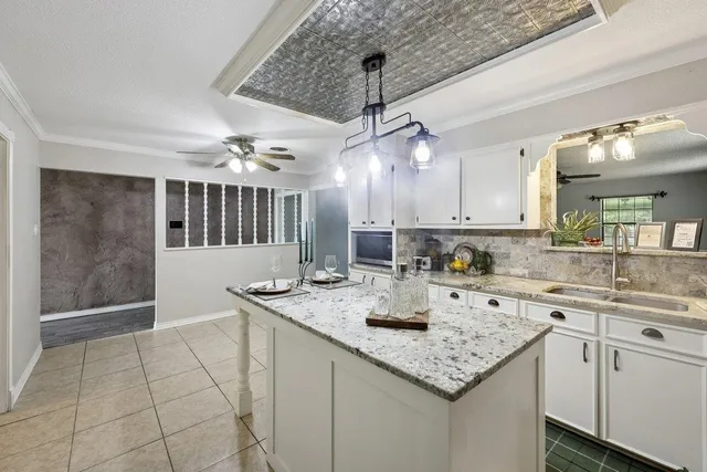 a kitchen with a sink a counter space cabinets and stainless steel appliances