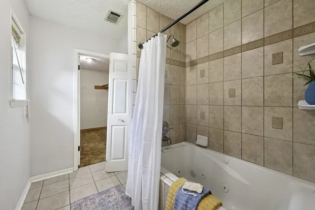a bathroom with a tub and shower