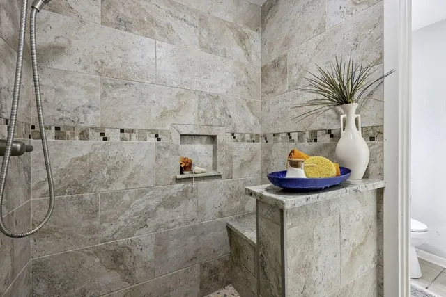 a bathroom with a sink a mirror and shower