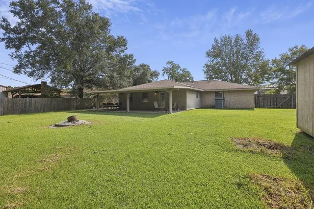 a view of a house with swimming pool and a yard