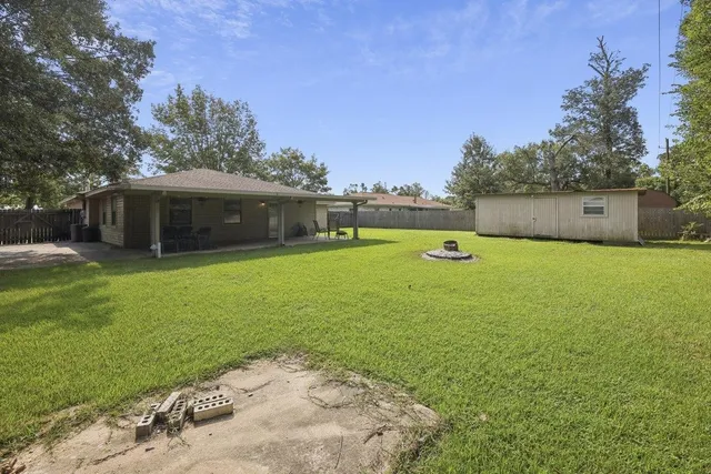 a view of a house with a yard and sitting area