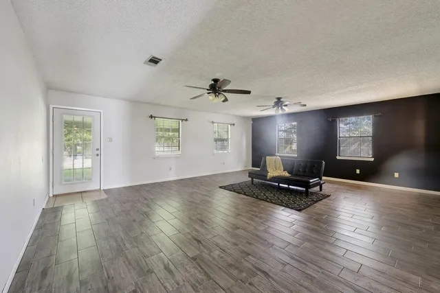a view of livingroom with hardwood floor and a ceiling fan