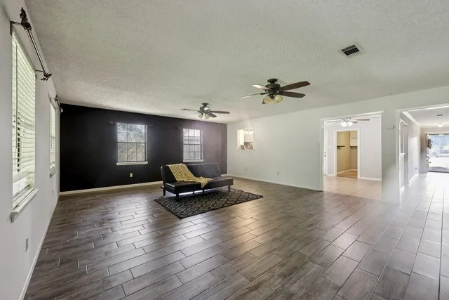 a living room with furniture window and wooden floor