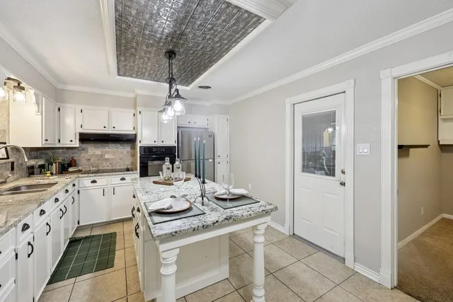 a kitchen with stainless steel appliances granite countertop a stove a refrigerator and a sink