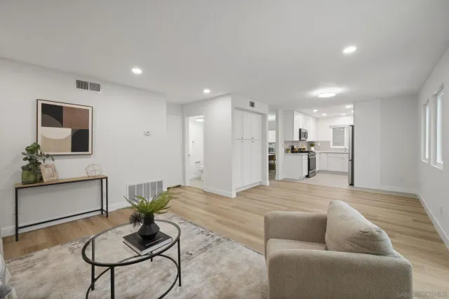a living room with furniture and kitchen view