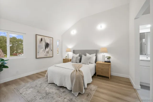 a bedroom with a bed and a painting on the wall