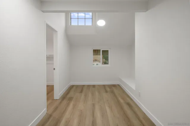a view of a room with wooden floor and window