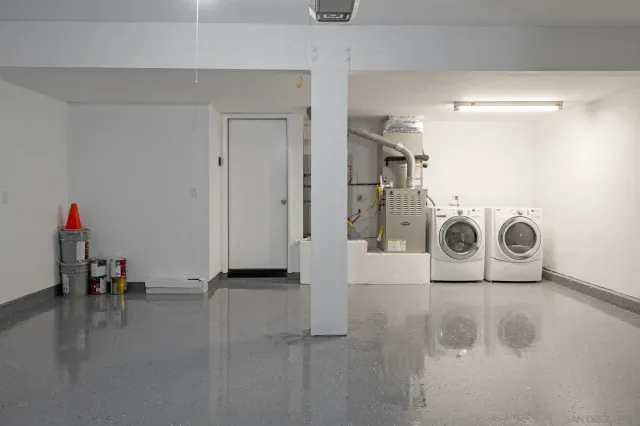 a view of a storage & utility room with two washing machine