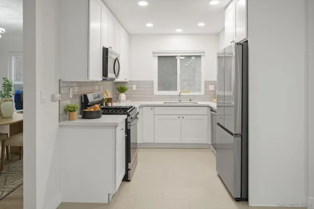 a kitchen with cabinets and window