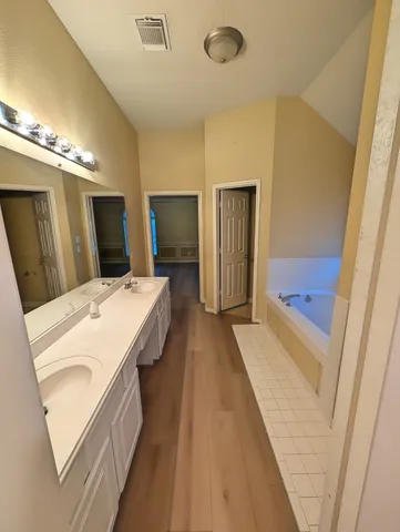 a bed room with a bed and a mirror