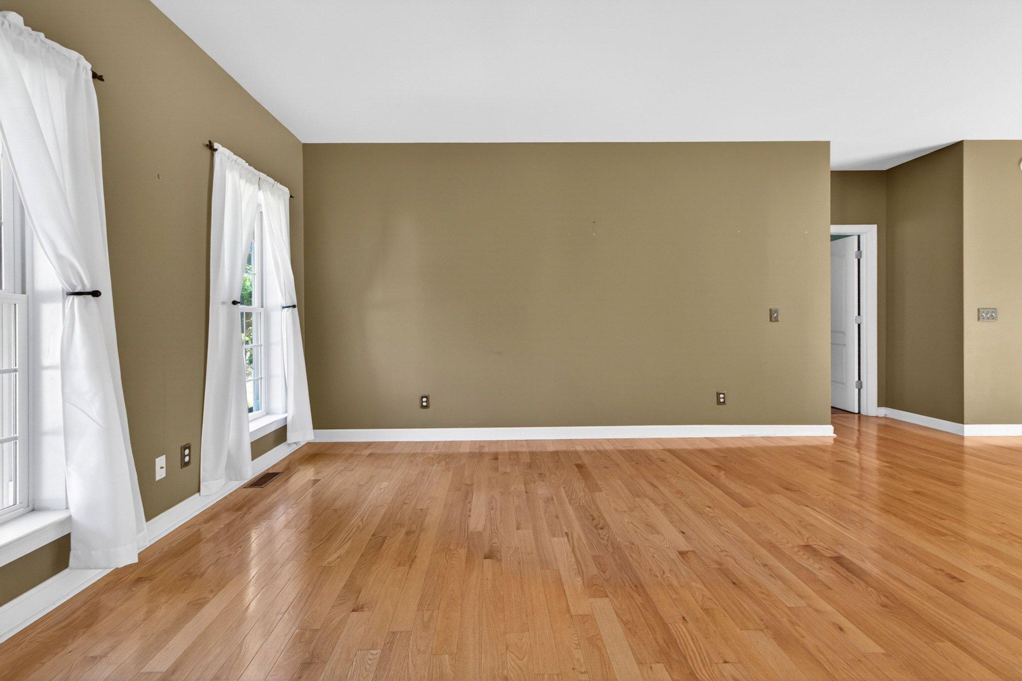 10878 Memory Road Harrington, DE 19952 - Photo 14 of 94 an empty room with wooden floor and windows