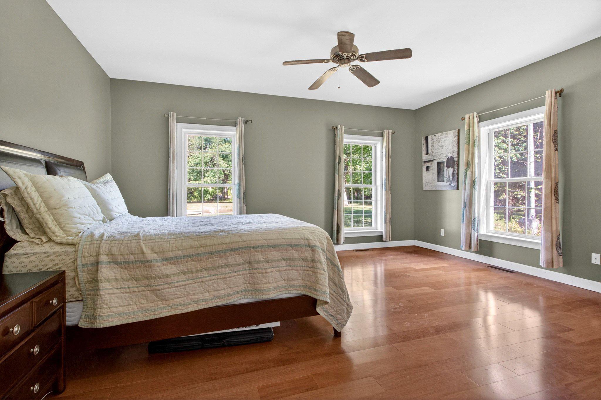 10878 Memory Road Harrington, DE 19952 - Photo 15 of 94 a bedroom with a large bed and a large window