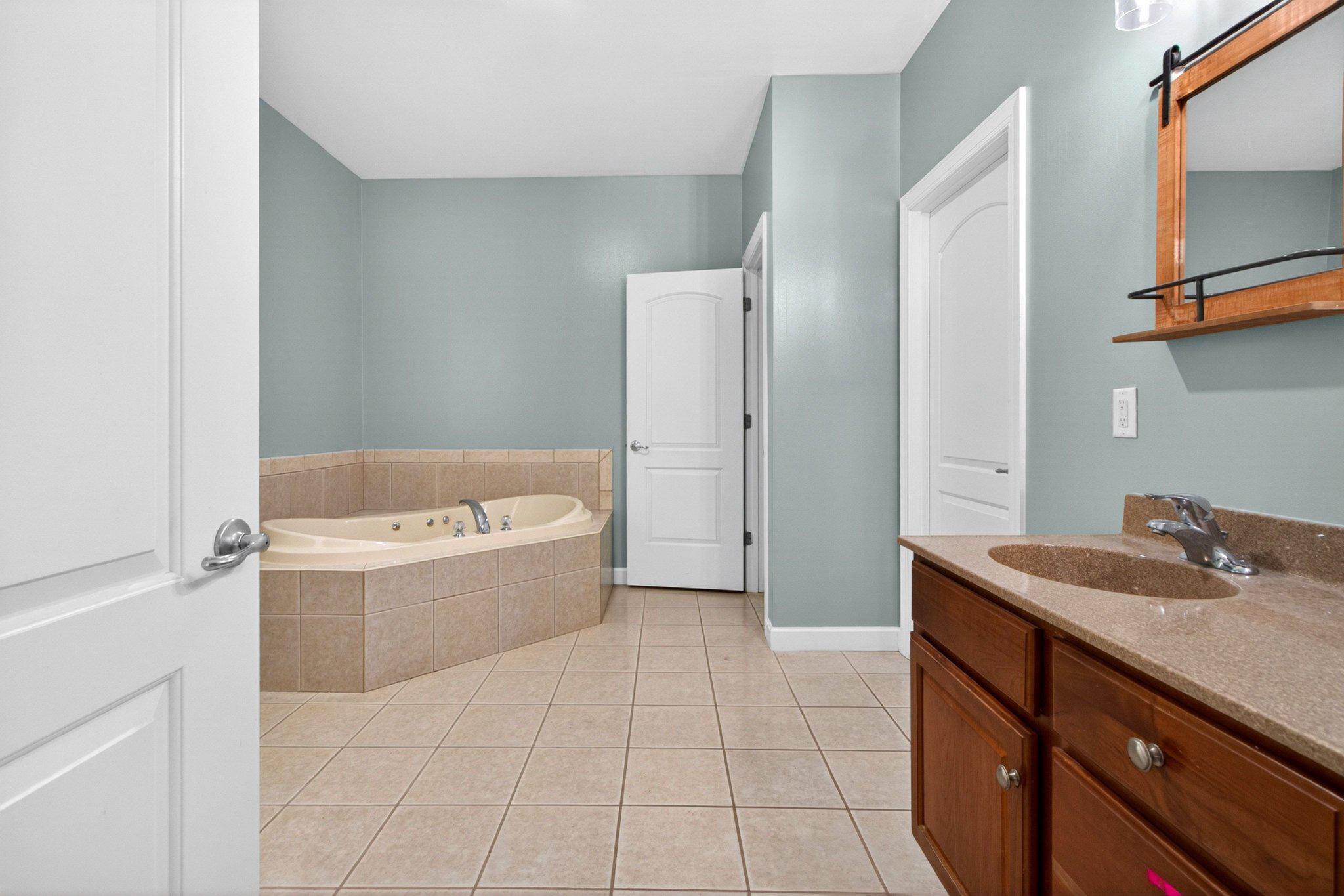 10878 Memory Road Harrington, DE 19952 - Photo 20 of 94 a bathroom with a tub sink and mirror