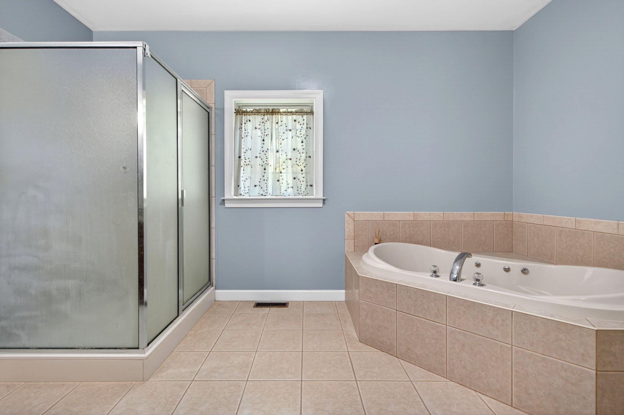 10878 Memory Road Harrington, DE 19952 - Photo 21 of 94 a bathroom with a bathtub and a shower