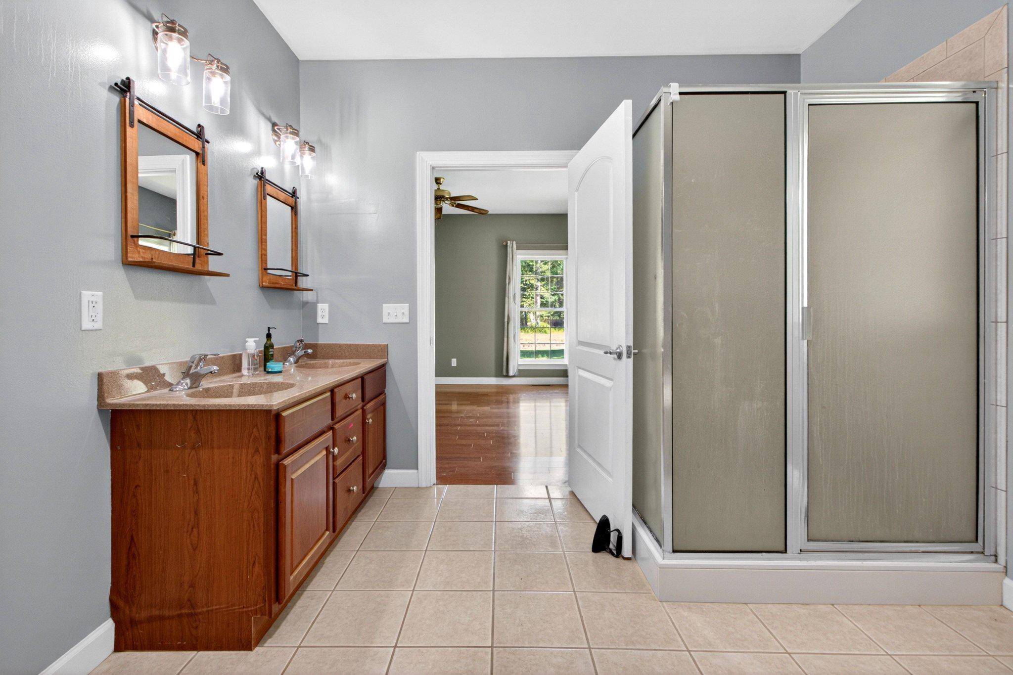 10878 Memory Road Harrington, DE 19952 - Photo 22 of 94 a spacious bathroom with a double vanity sink and a mirror