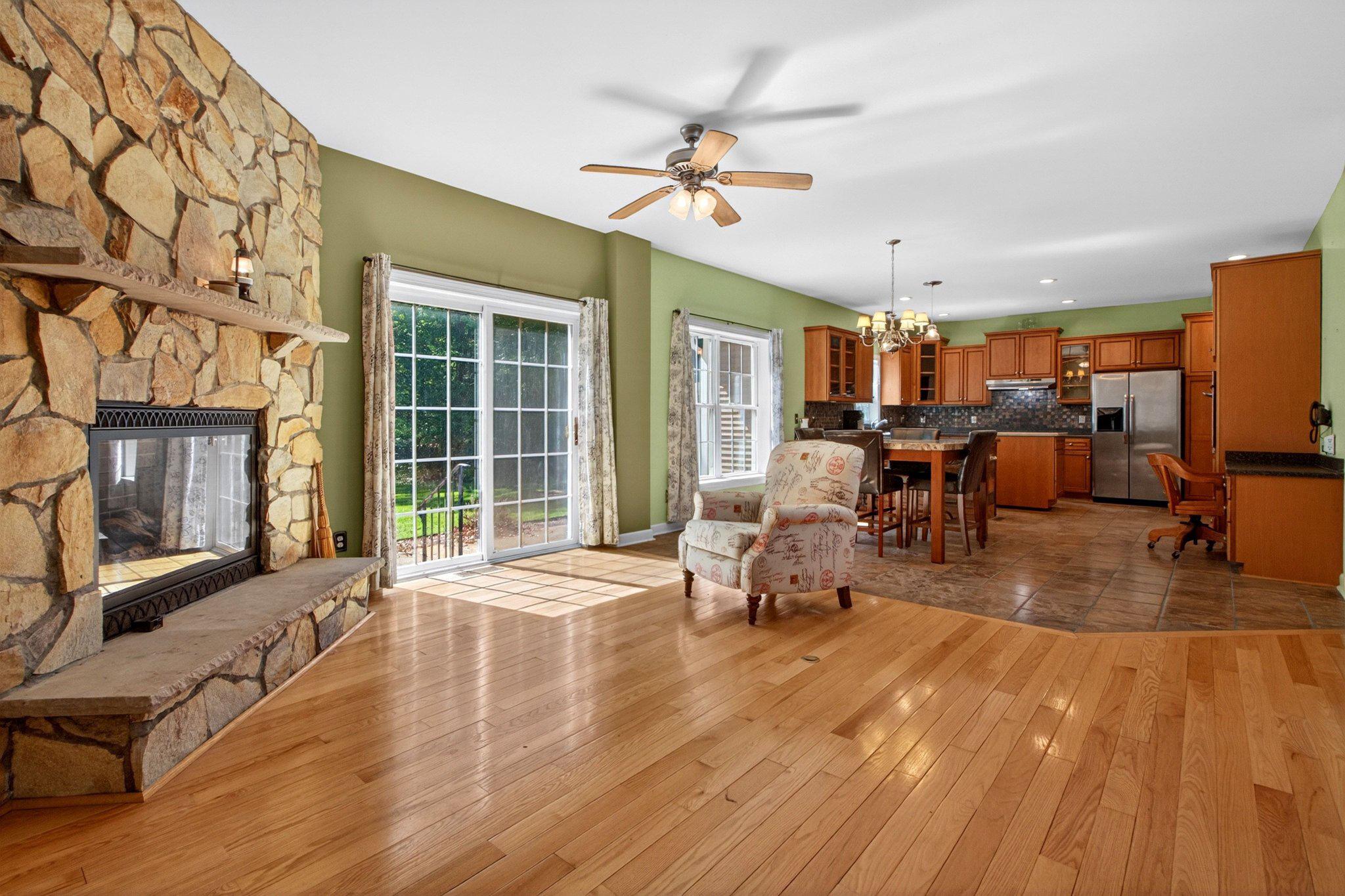 10878 Memory Road Harrington, DE 19952 - Photo 27 of 94 a living room with furniture a flat screen tv and a floor to ceiling window